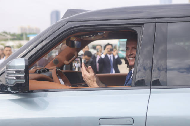 △在深圳，紐森現場試乘比亞迪電動汽車。