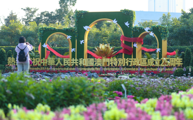 12月17日，市民在澳門一處慶祝花壇前拍照。新華社發